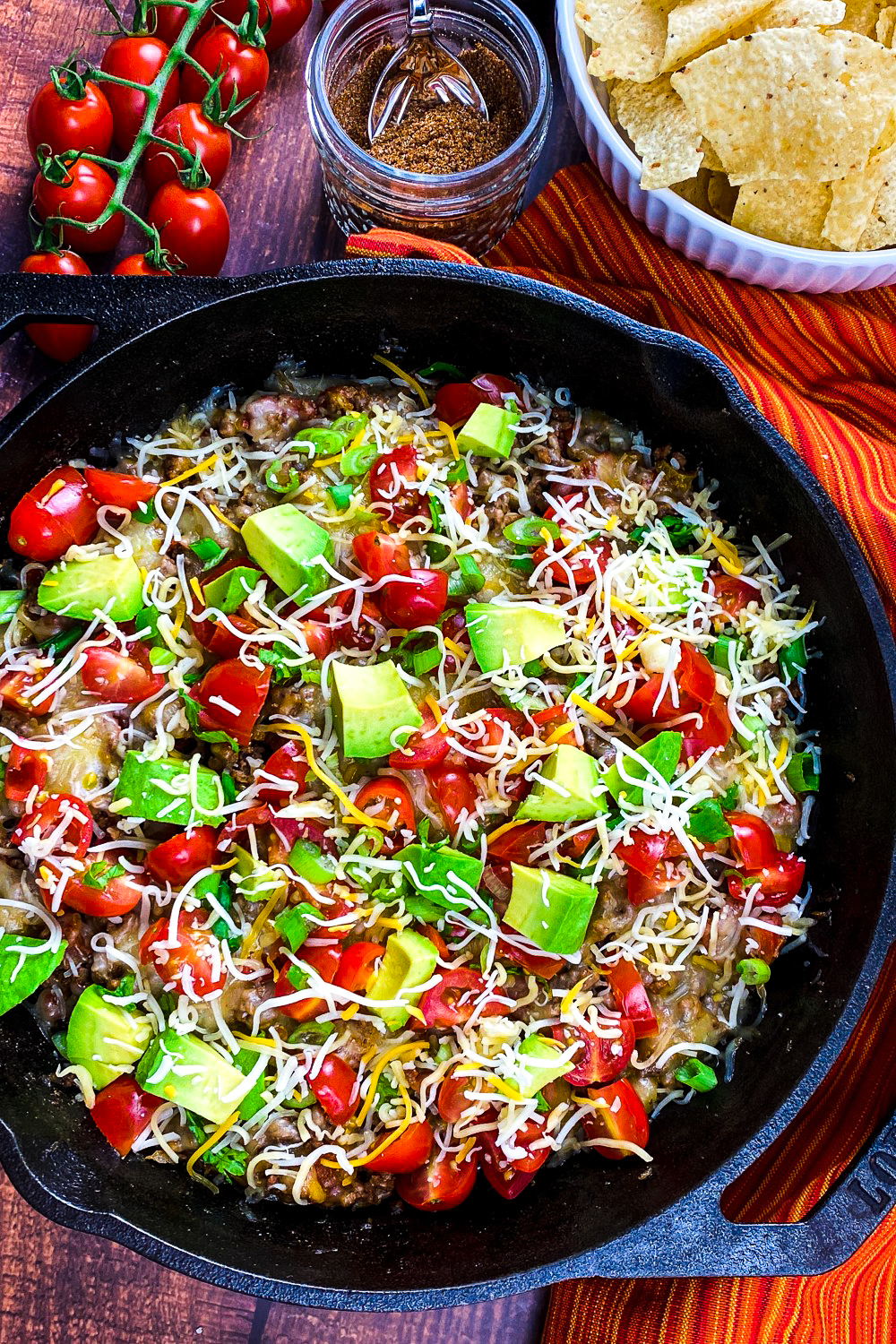 This recipe for an easy beef taco skillet makes a hearty family meal or serve with tortilla chips instead for an addictive appetizer!