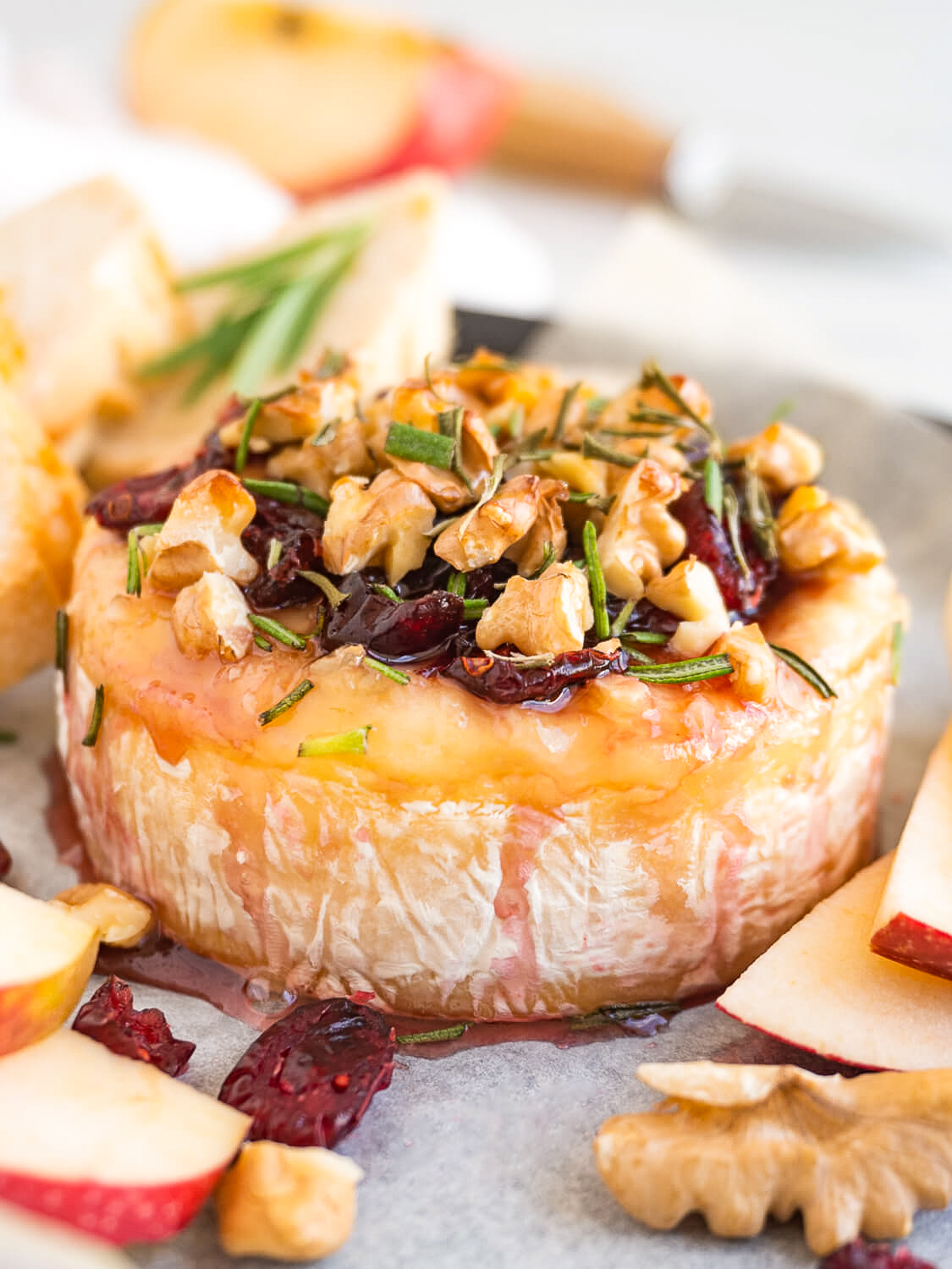 Learn how to make baked brie with cranberries and walnuts, it's the perfect holiday party appetizer. It's quick, fancy, and tastes delicious!