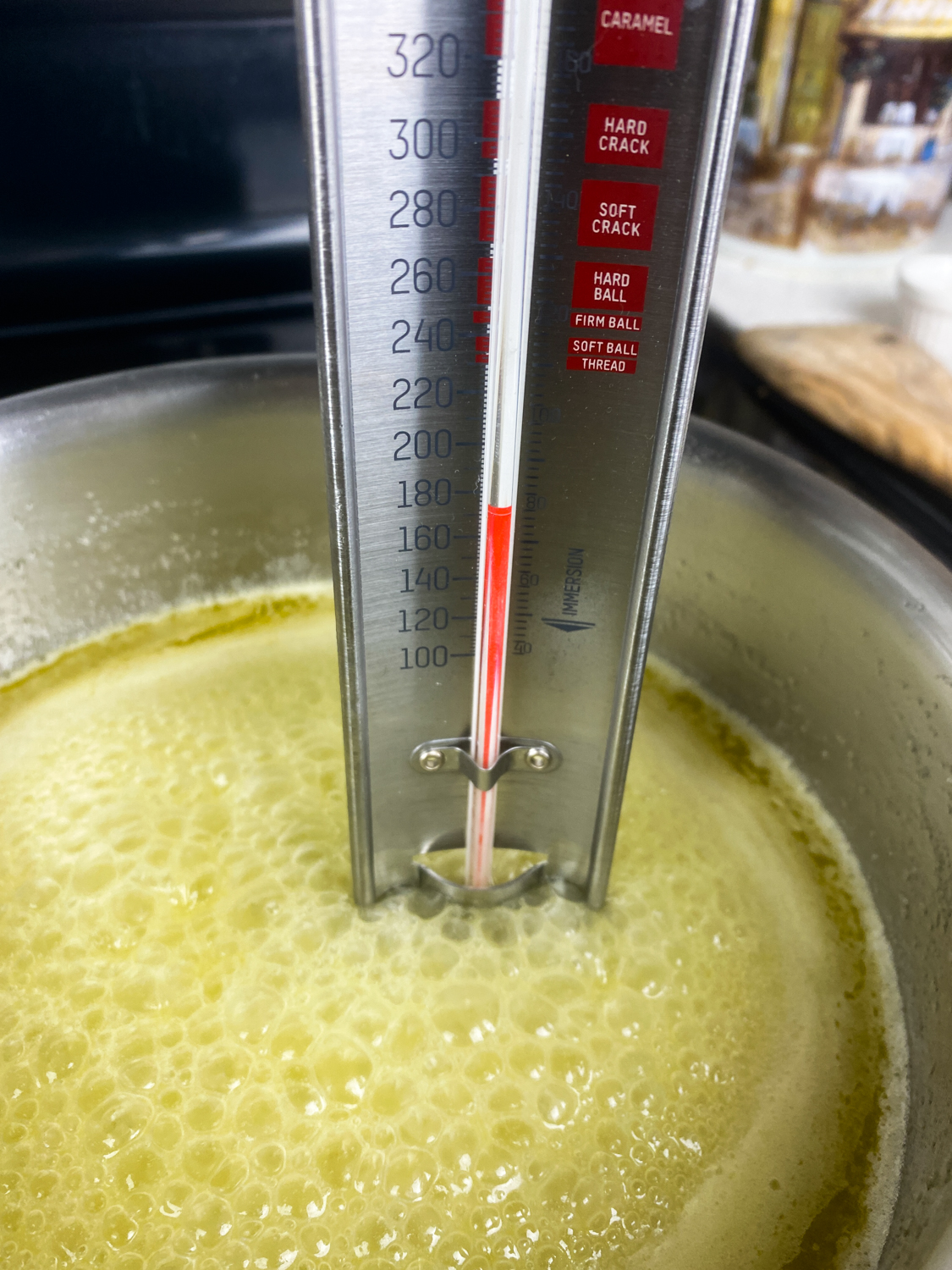 Butter and sugar melted in a large pot with a candy thermometer in it.