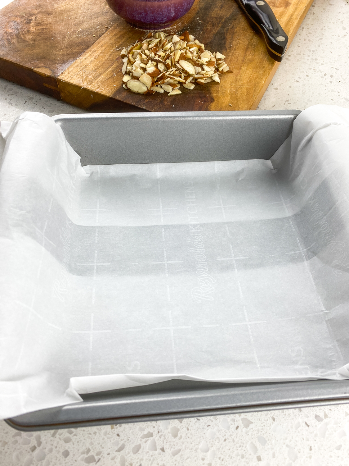 Parchment folded to make a sling and laid out inside a baking pan.