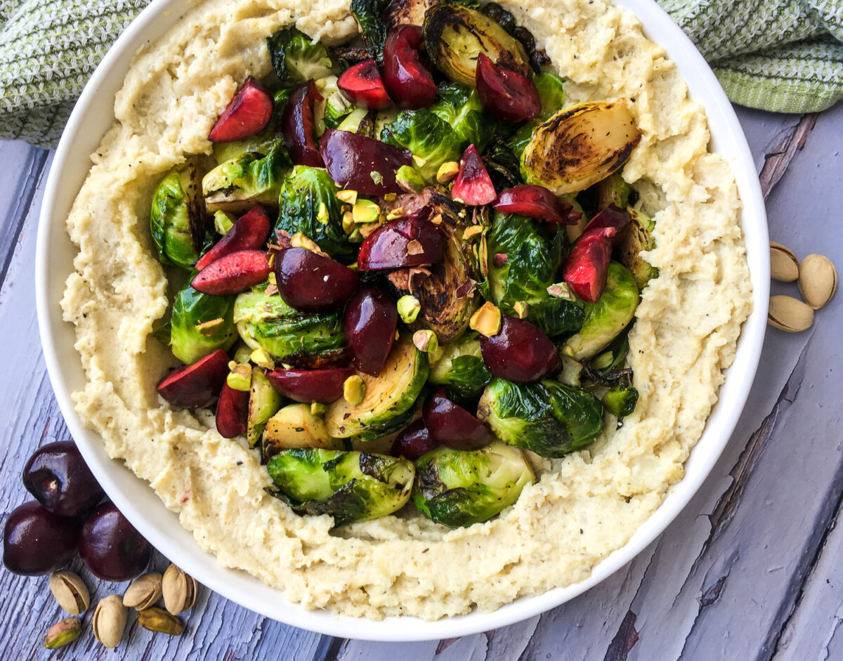 This roasted apple cauliflower mash recipe, with crispy brussels sprouts is a healthy side dish that's rich in flavour.