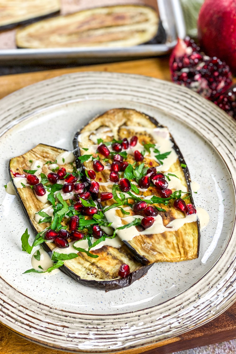 Roasted Eggplant with Pomegranate & Tahini Dressing is a delectable Middle Eastern inspired dish that's great as a side or a vegetarian meal.