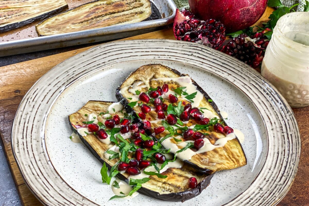 Roasted Eggplant with Pomegranate & Tahini Dressing is a delectable Middle Eastern inspired dish that's great as a side or a vegetarian meal.