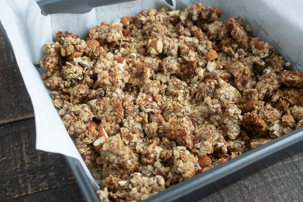 Preparing the granola to bake in the oven.