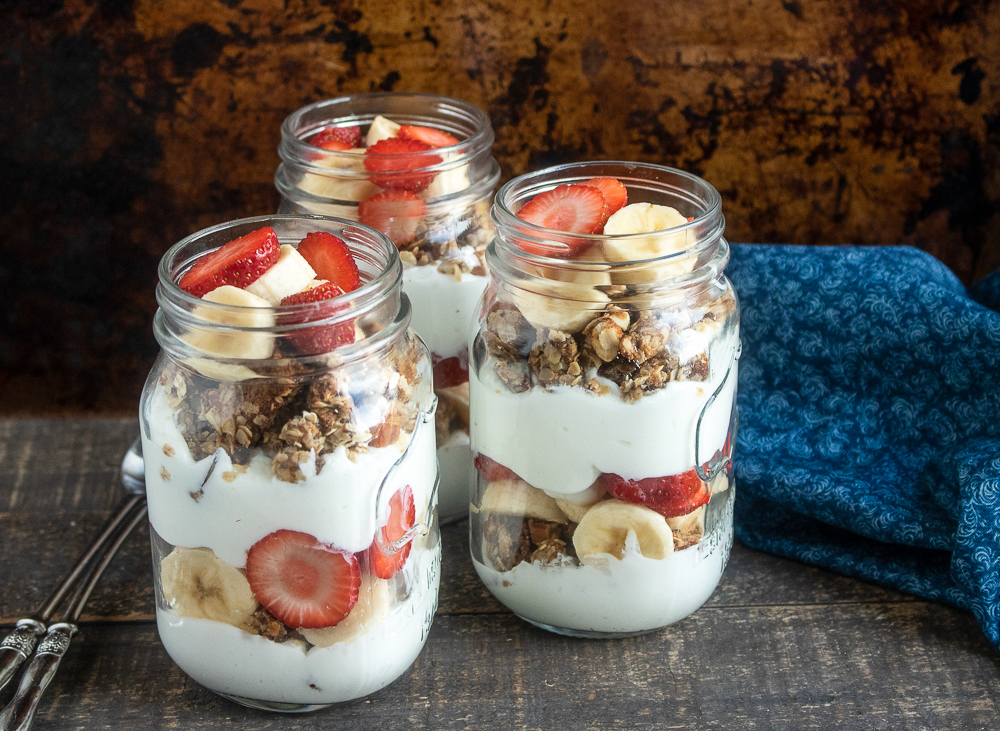 This healthy breakfast parfait recipe is made with homemade granola, Greek yogurt and fresh strawberries and bananas.