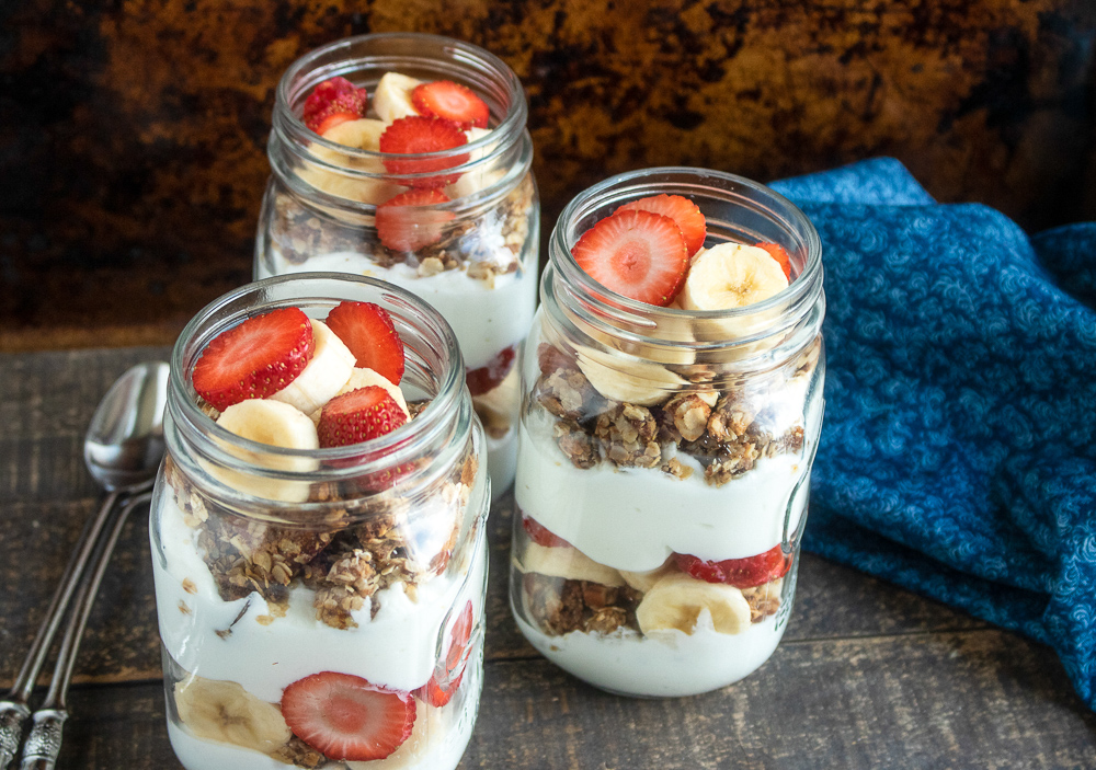 This healthy breakfast parfait recipe is made with homemade granola, Greek yogurt and fresh strawberries and bananas.