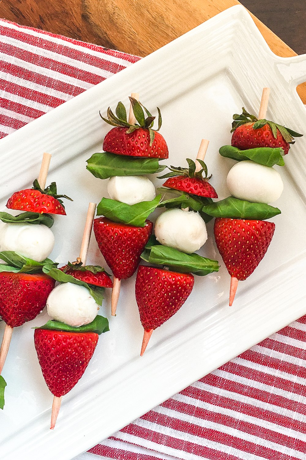 A summer party or dinner idea, these strawberry caprese skewers drizzled in balsamic glaze are perfect appetizers for a party!