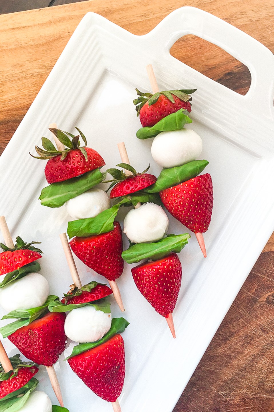 A summer party or dinner idea, these strawberry caprese skewers drizzled in balsamic glaze are perfect appetizers for a party!