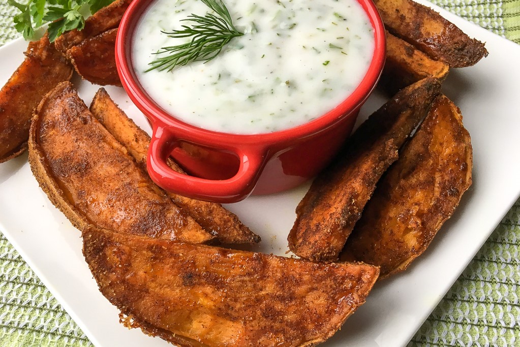 These crispy sweet potato wedges are crisp outside and soft on the inside, making them perfect for dipping in a delicious herbed yogurt dip.