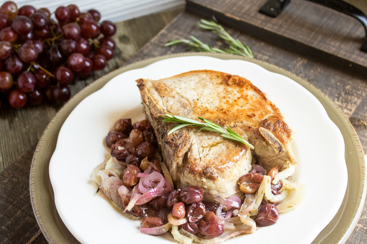 This Tuscan pork chop recipe is inspired by the flavors of Tuscany; thick pan-seared pork chops with sweet roasted grapes and earthy fennel.