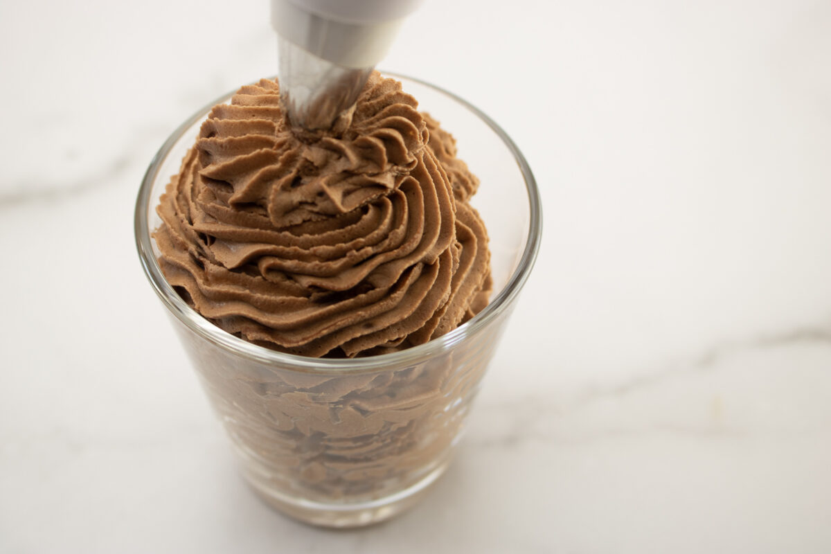 Piping the chocolate mousse into a glass.
