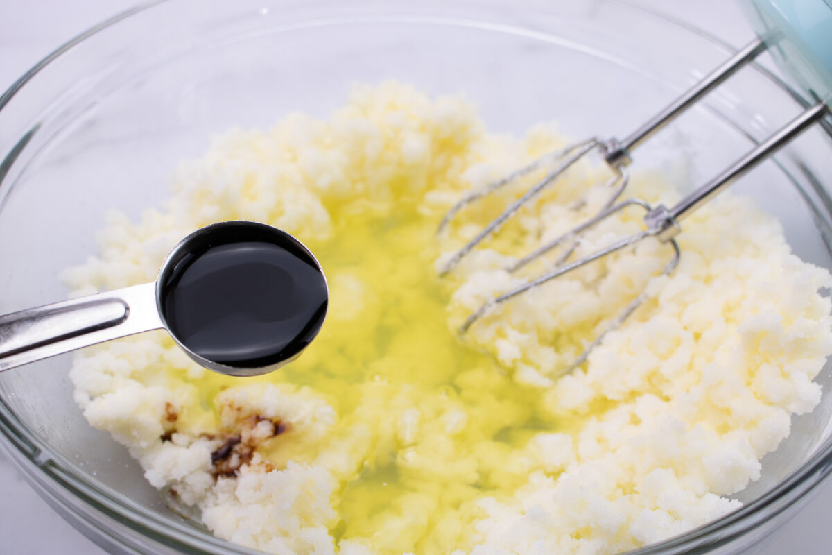 Creaming together the butter, shortening and sugar in a large mixing bowl.