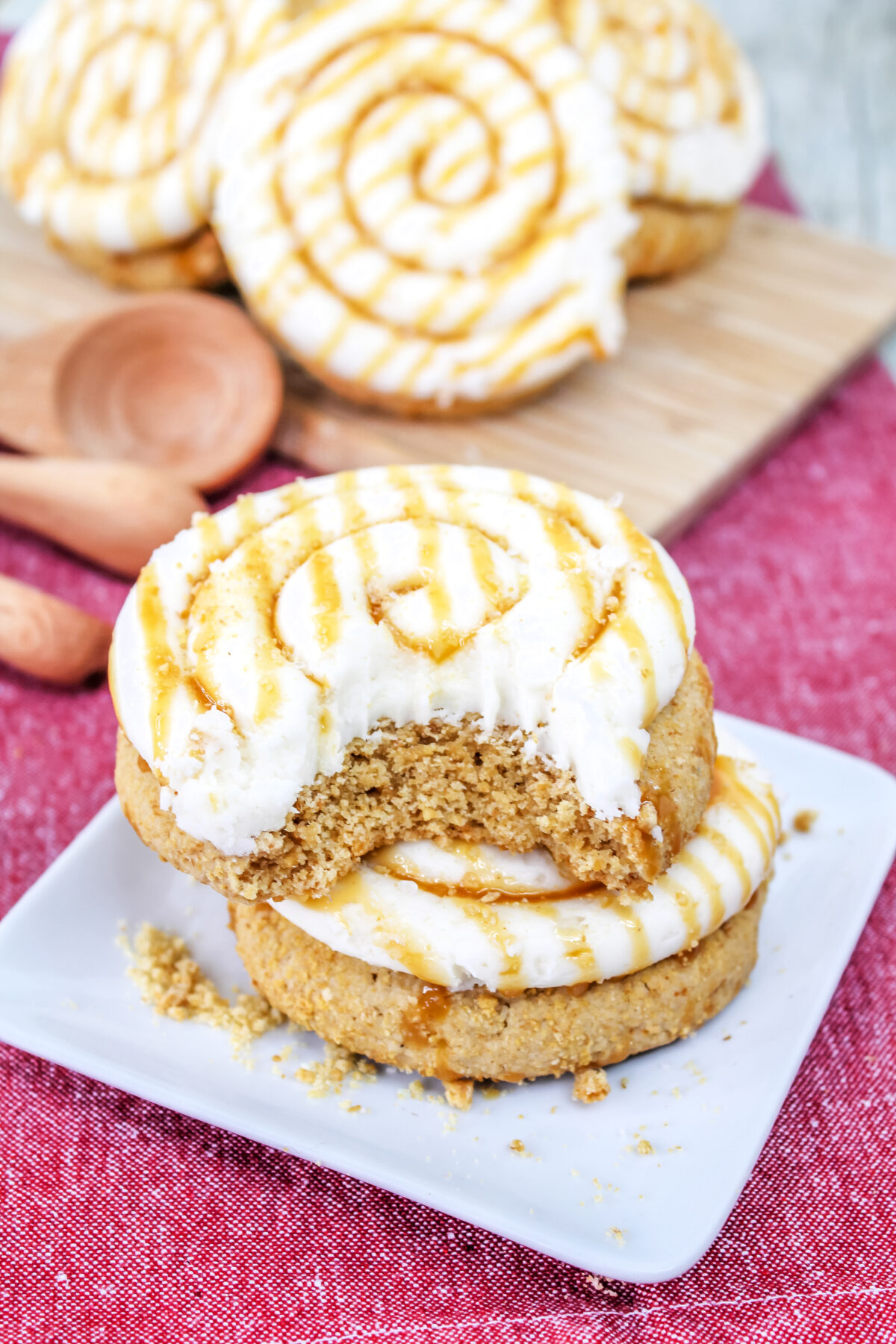 These Crumbl Salted Caramel Cheesecake Cookies feature a buttery cookie frosted with creamy cheesecake frosting drizzled with salted caramel.