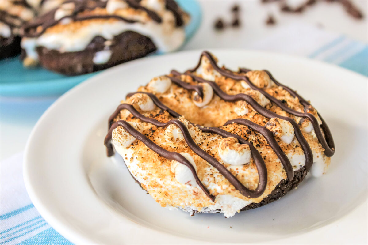 Indulge in your summer camp memories with these delicious s'mores chocolate donuts! They're perfect for a sweet snack or dessert.