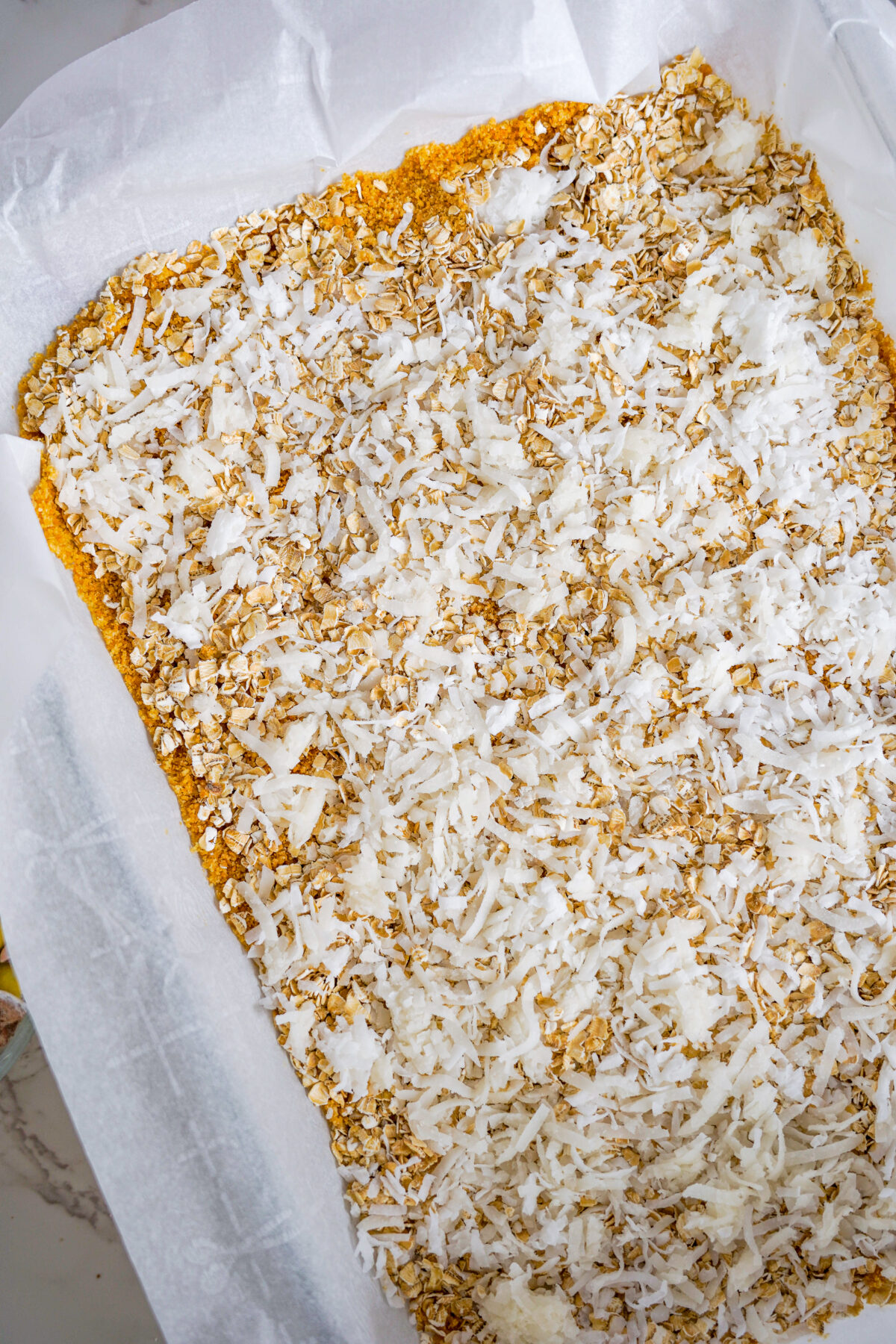 Oats and coconut flakes sprinkled over the crust.