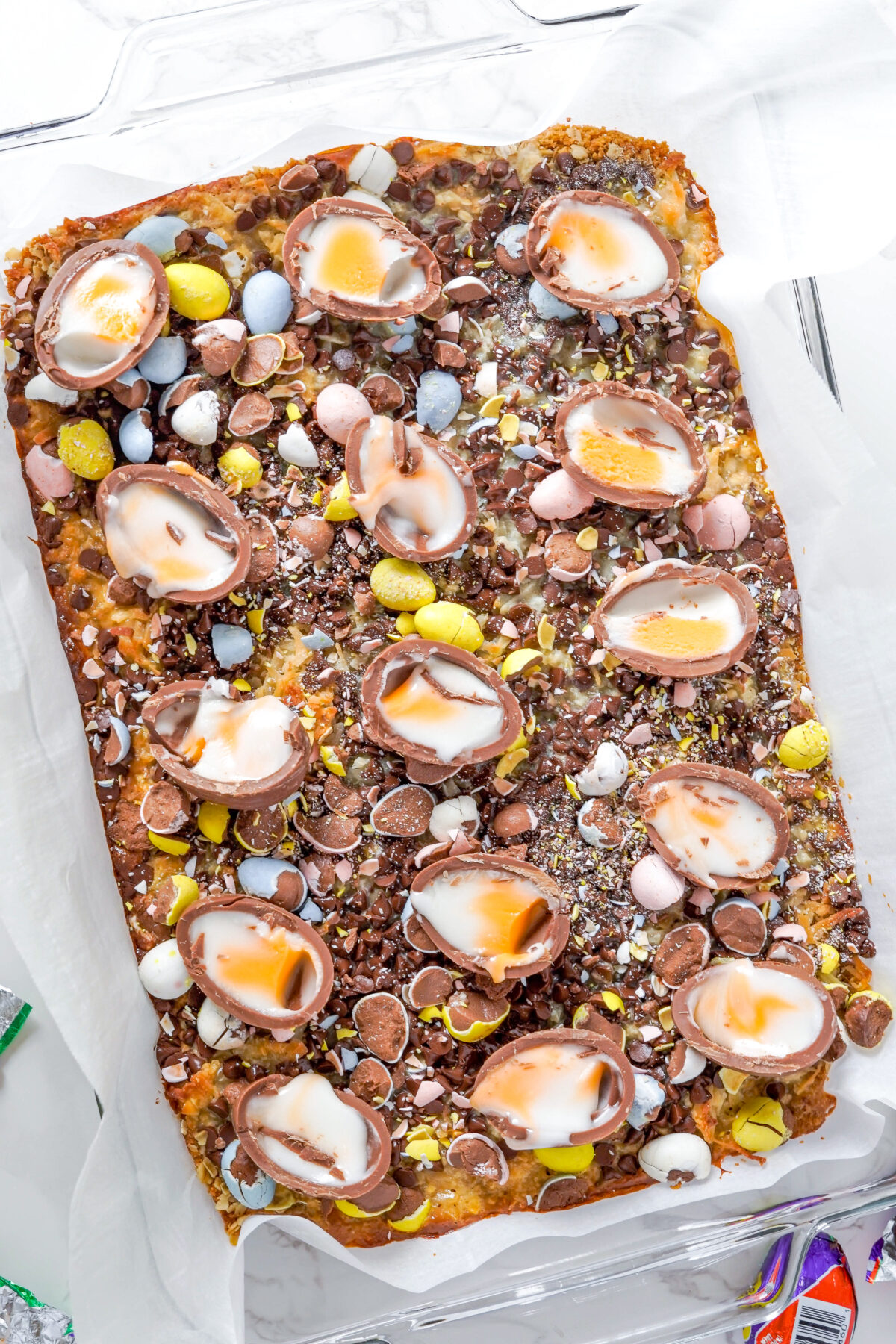 Magic cookie bars topped with creme eggs.