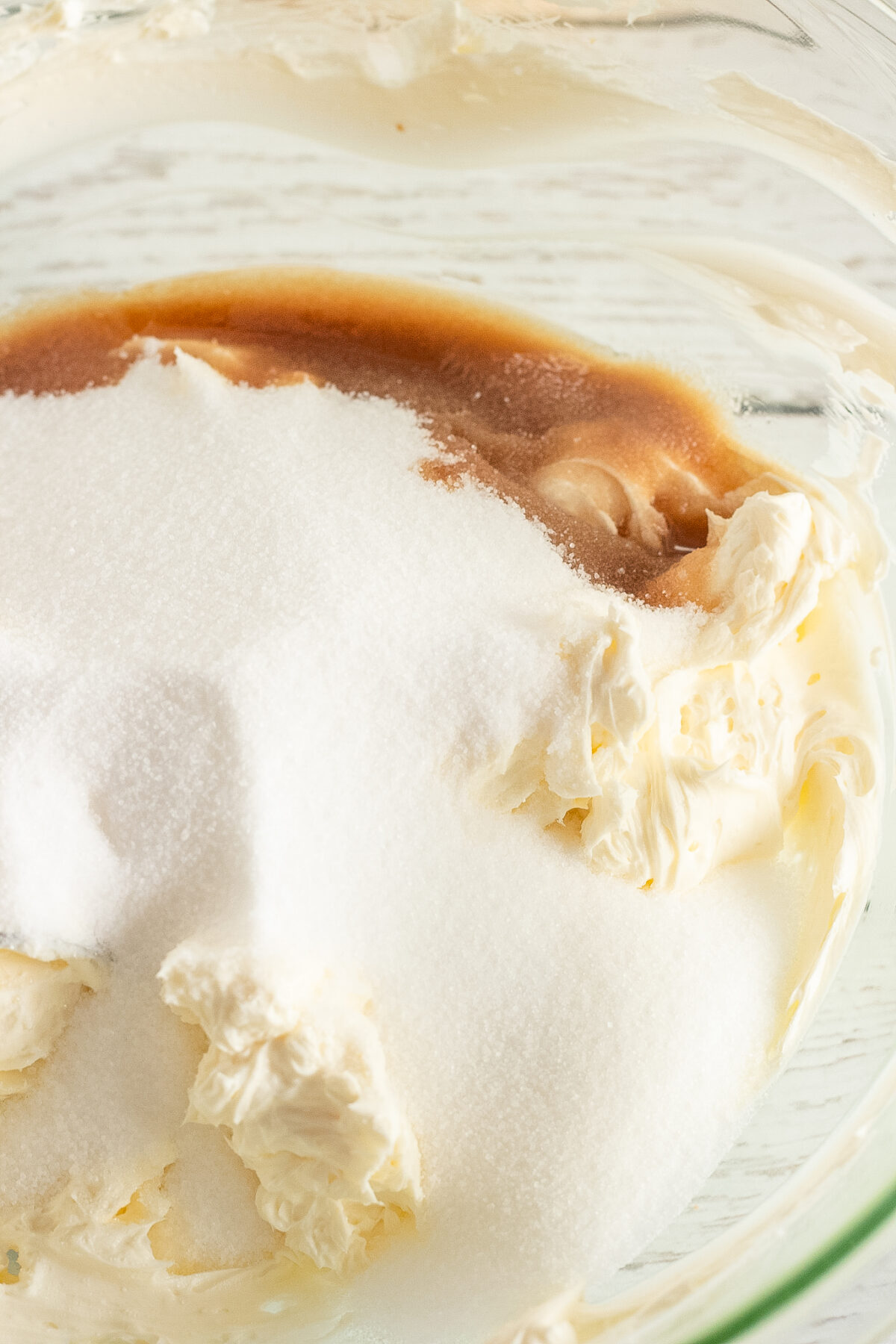 Sugar, salt, vanilla poured into the cream cheese.