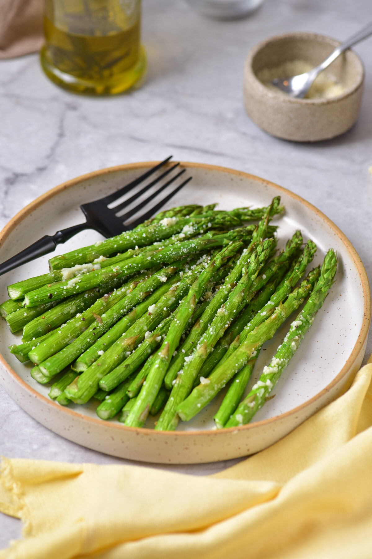 This flavourful and healthy air fryer asparagus side dish recipe is ready in just 15 minutes. Topped with Parmesan, it is sure to be a hit!