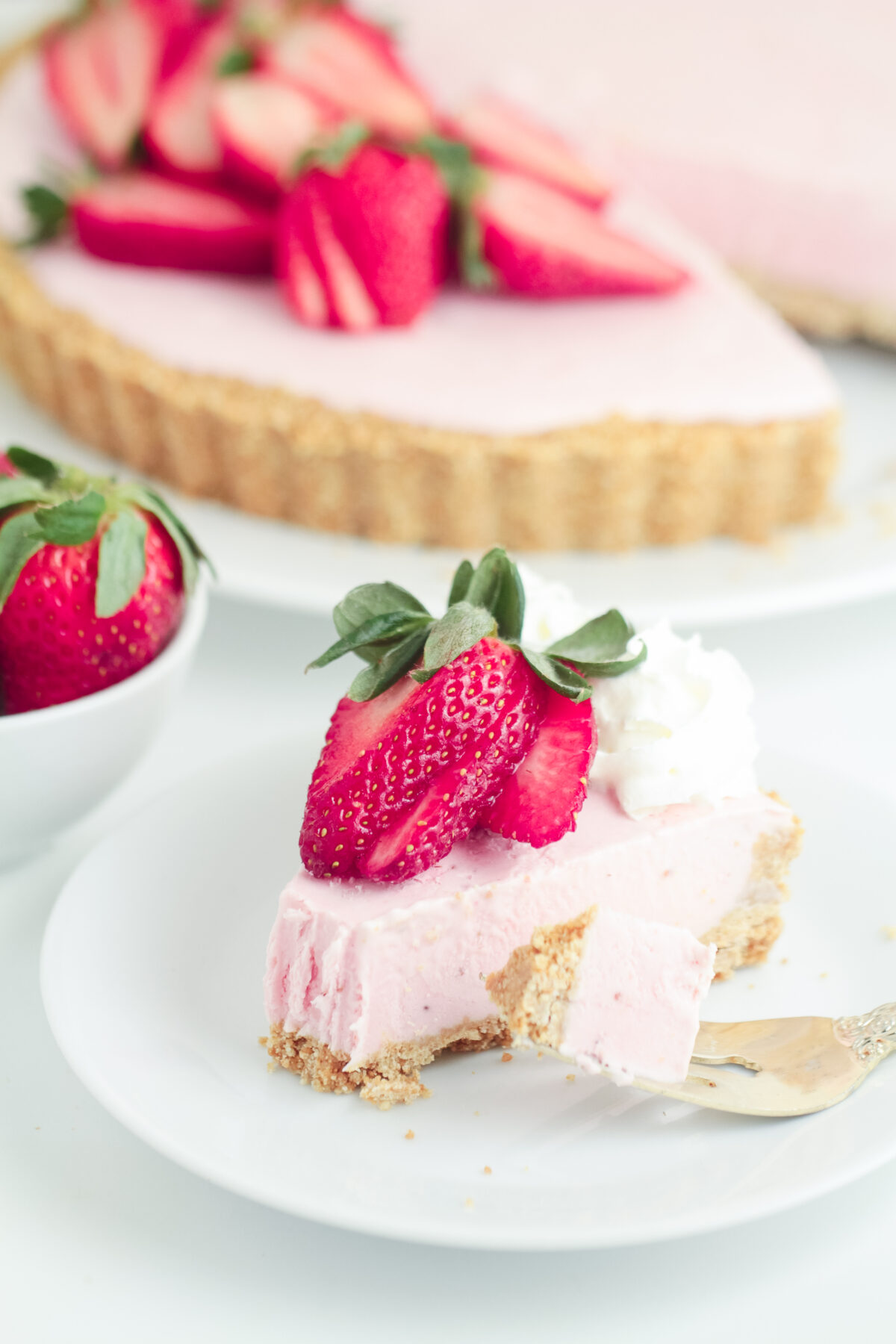 This easy No Bake Strawberry Cheesecake has a buttery cookie crust topped off with a creamy strawberry cheesecake filling.