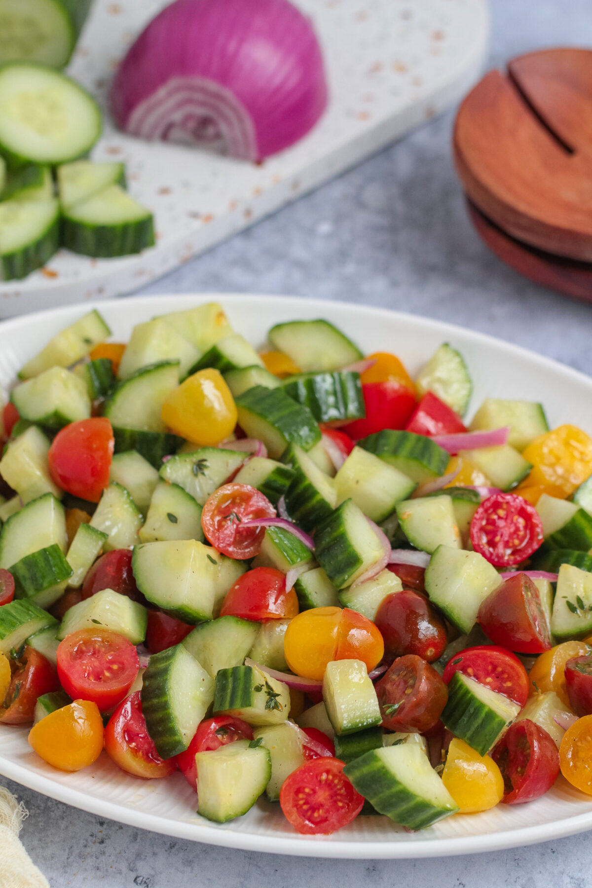 Fresh cucumber tomato salad with cherry tomatoes, red onion, thyme, and a simple vinaigrette. An easy summer side dish for any meal.